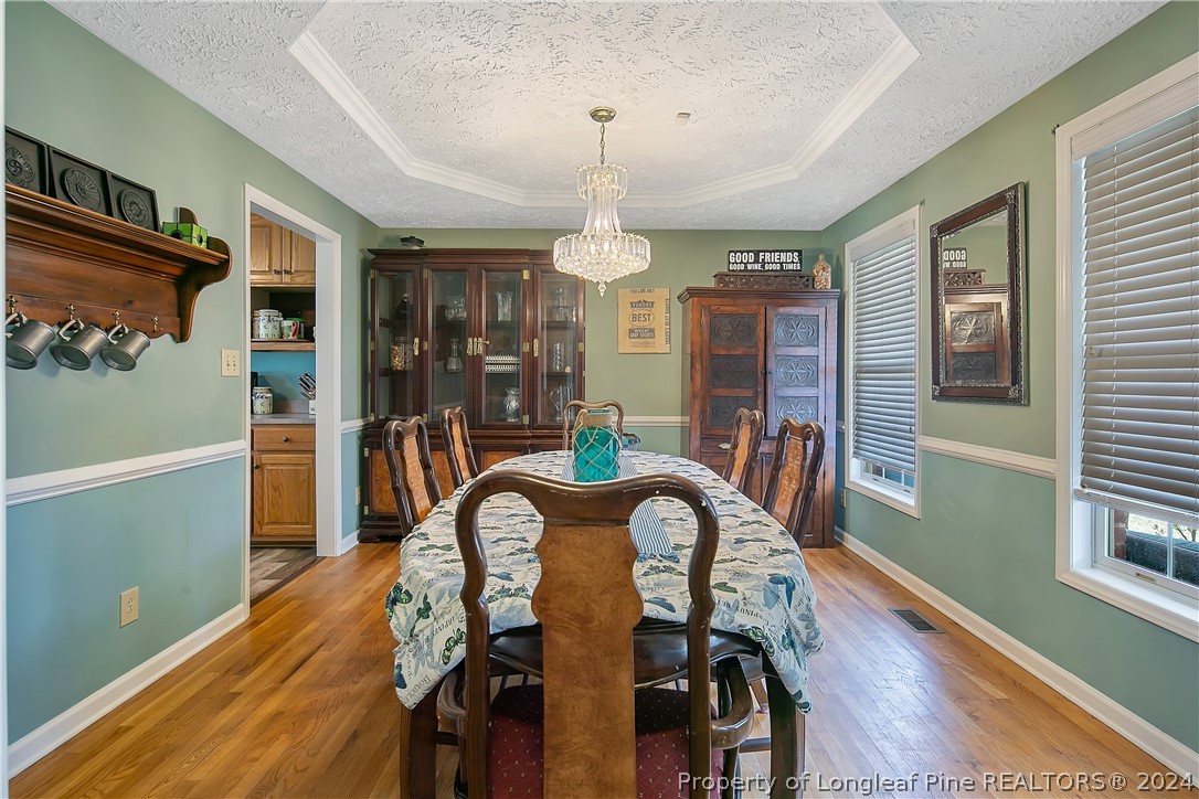 7833 Shuttle Road Fayetteville, NC 28311 - Photo 9 of 46 a view of a dining room with furniture window and wooden floor