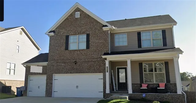 a view of a brick house with large windows
