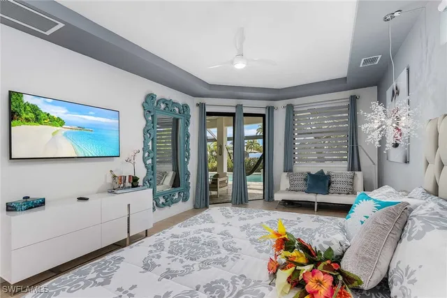 a bedroom with furniture and a flat screen tv