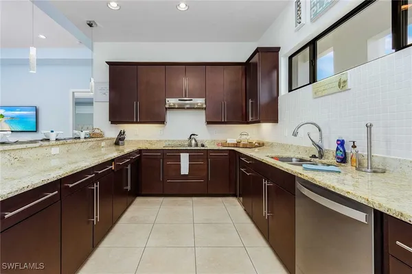 a kitchen with a sink stove top oven and cabinets