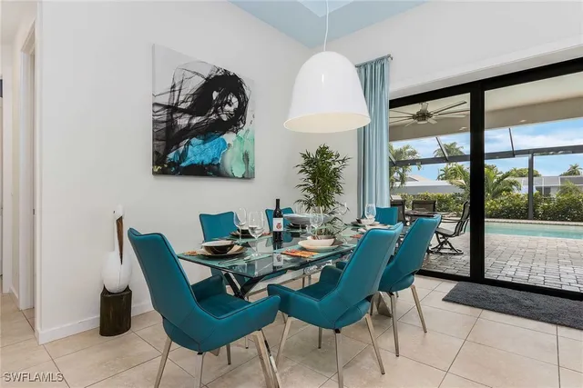 a dining room with furniture and a large window