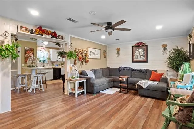 a living room with furniture and a wooden floor