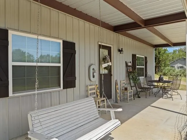a view of a patio with table and chairs