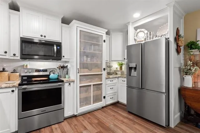 a kitchen with stainless steel appliances a refrigerator stove and microwave