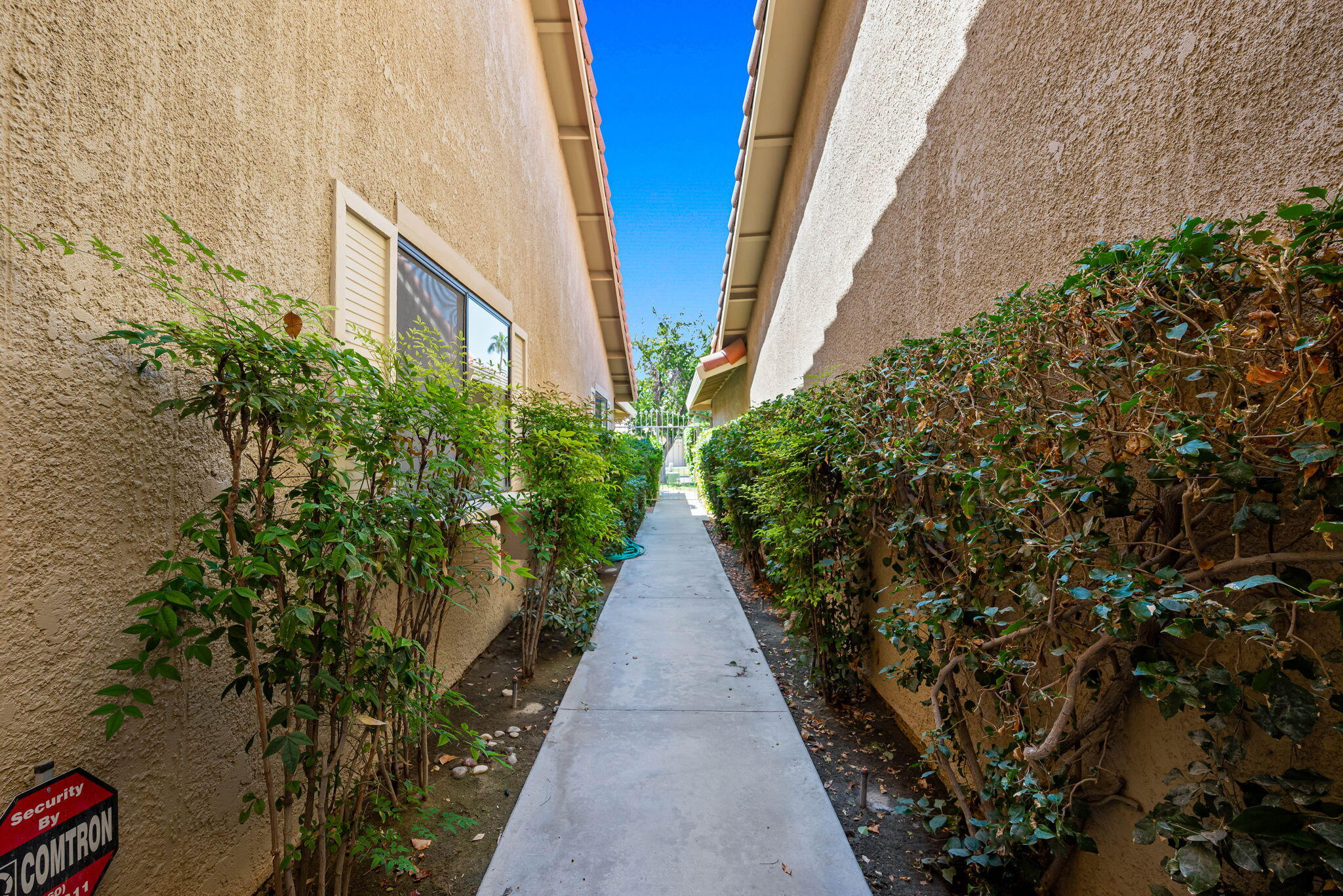 4 Maximo Way Palm Desert, CA 92260 - Photo 10 of 51 a view of a pathway with house on both side