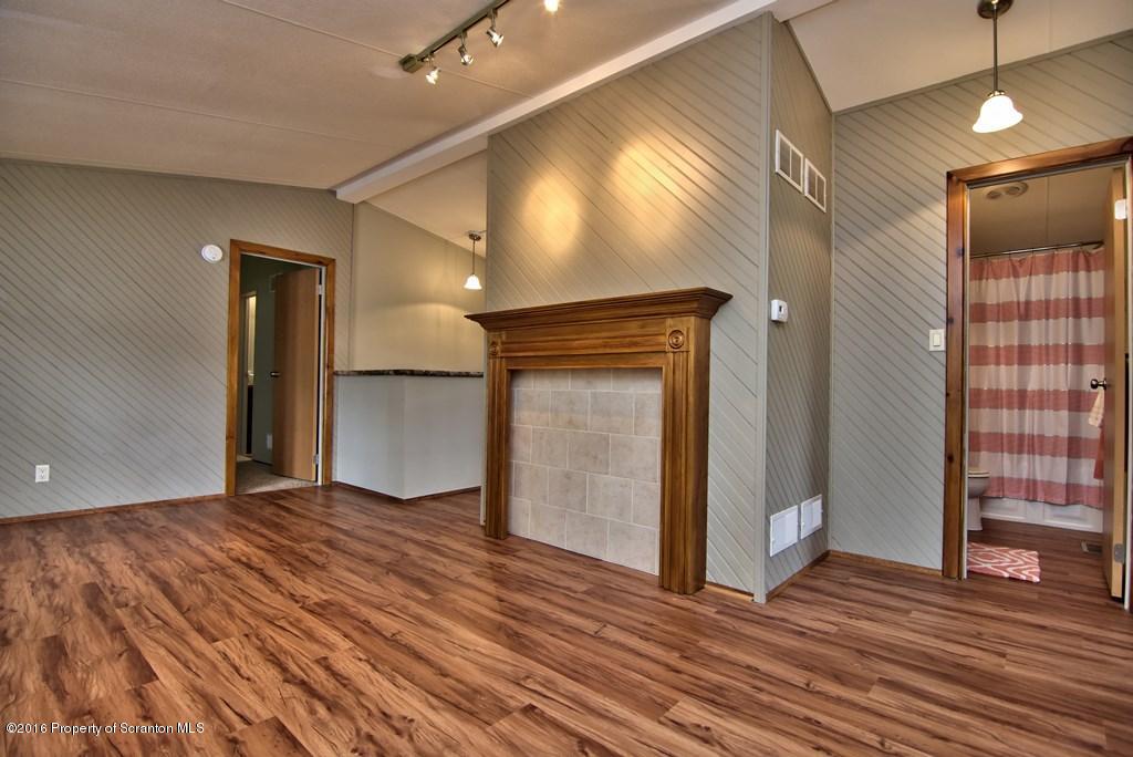 2131 Madisonville Road Moscow, PA 18444 - Photo 14 of 49 a view of empty room with wooden floor and fan