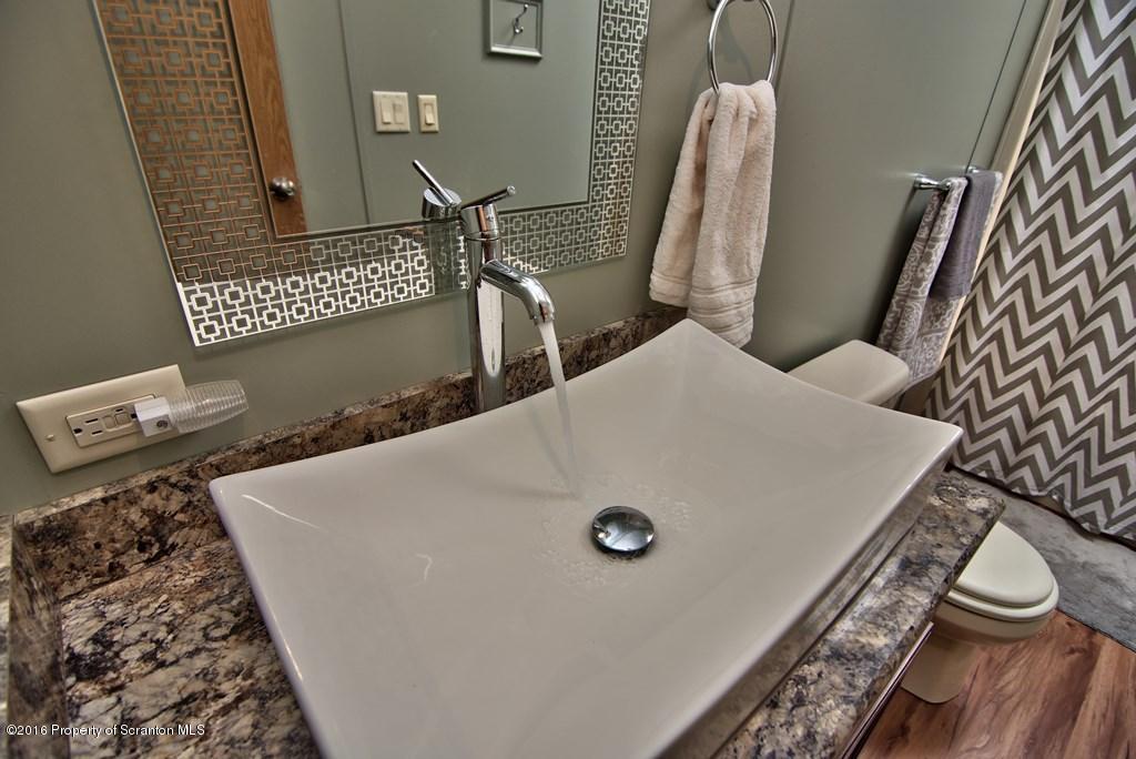 2131 Madisonville Road Moscow, PA 18444 - Photo 28 of 49 a bathroom with a granite countertop sink and a toilet
