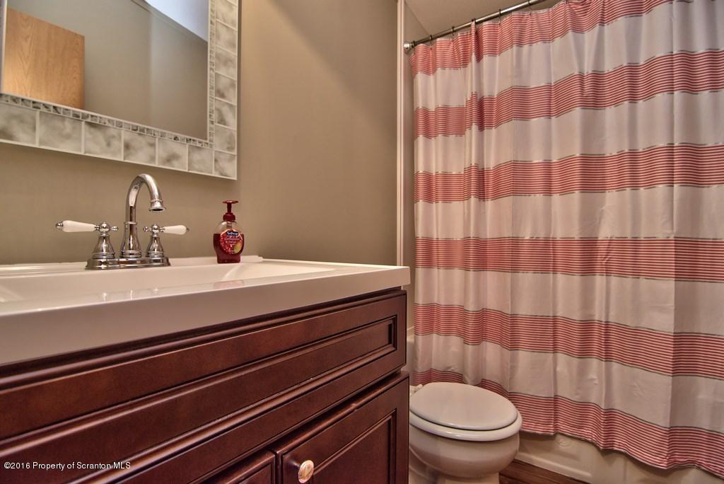 2131 Madisonville Road Moscow, PA 18444 - Photo 33 of 49 a bathroom with a sink a toilet a mirror and shower curtain