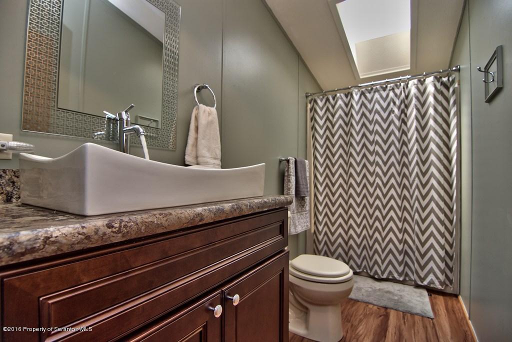 2131 Madisonville Road Moscow, PA 18444 - Photo 5 of 49 a bathroom with a granite countertop toilet sink and mirror