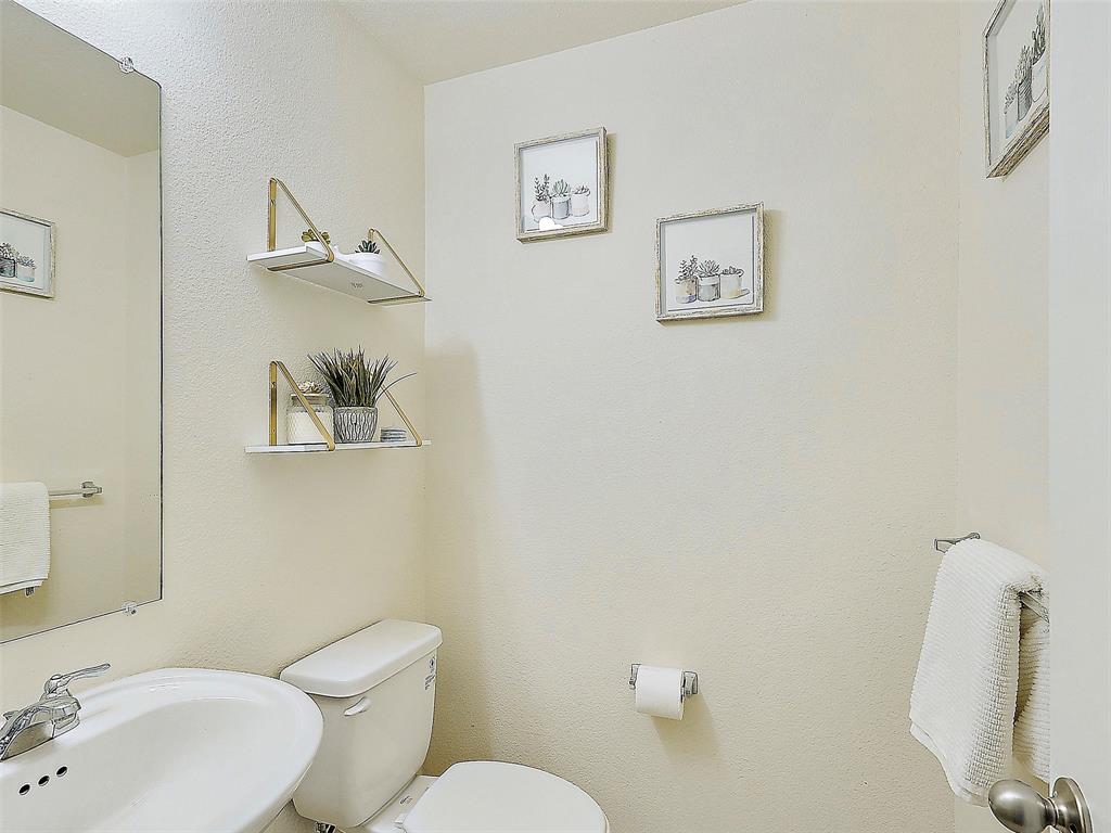 2549 Saddlehorn Drive Little Elm, TX 75068 - Photo 11 of 23 a white toilet sitting next to a bathroom sink