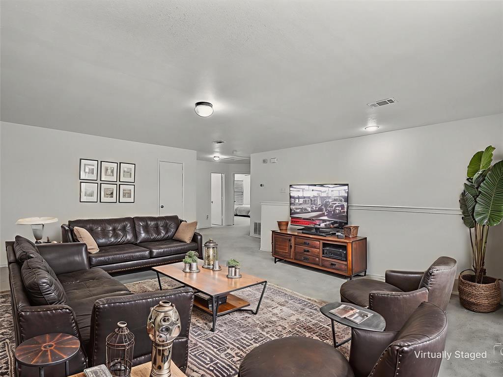 2549 Saddlehorn Drive Little Elm, TX 75068 - Photo 14 of 23 a living room with furniture and a flat screen tv