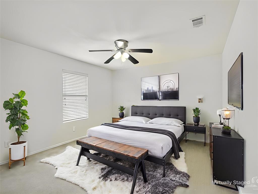 2549 Saddlehorn Drive Little Elm, TX 75068 - Photo 17 of 23 a bedroom with a bed and a chandelier