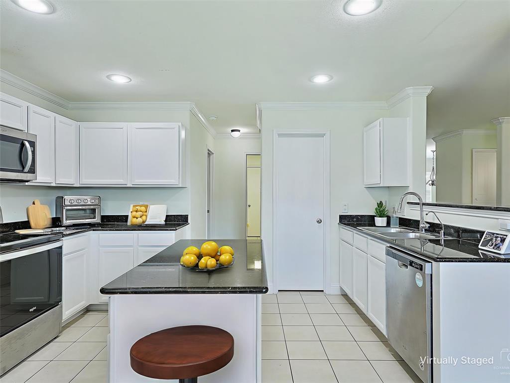 2549 Saddlehorn Drive Little Elm, TX 75068 - Photo 2 of 23 a kitchen with a sink a stove and cabinets