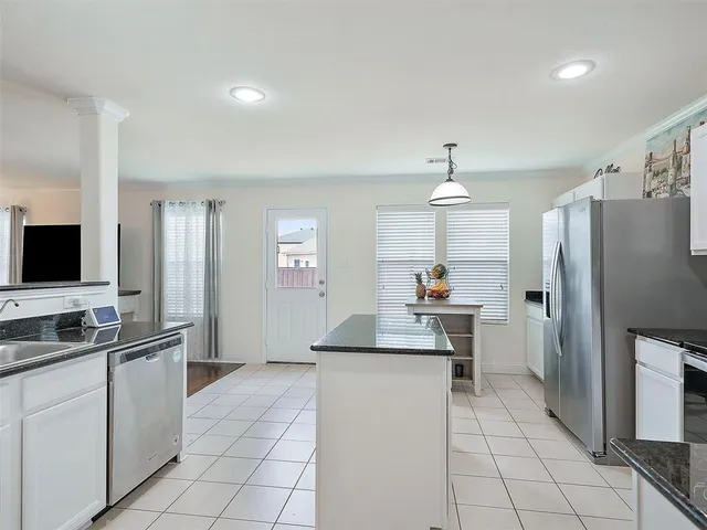 a kitchen with stainless steel appliances a sink stove and refrigerator