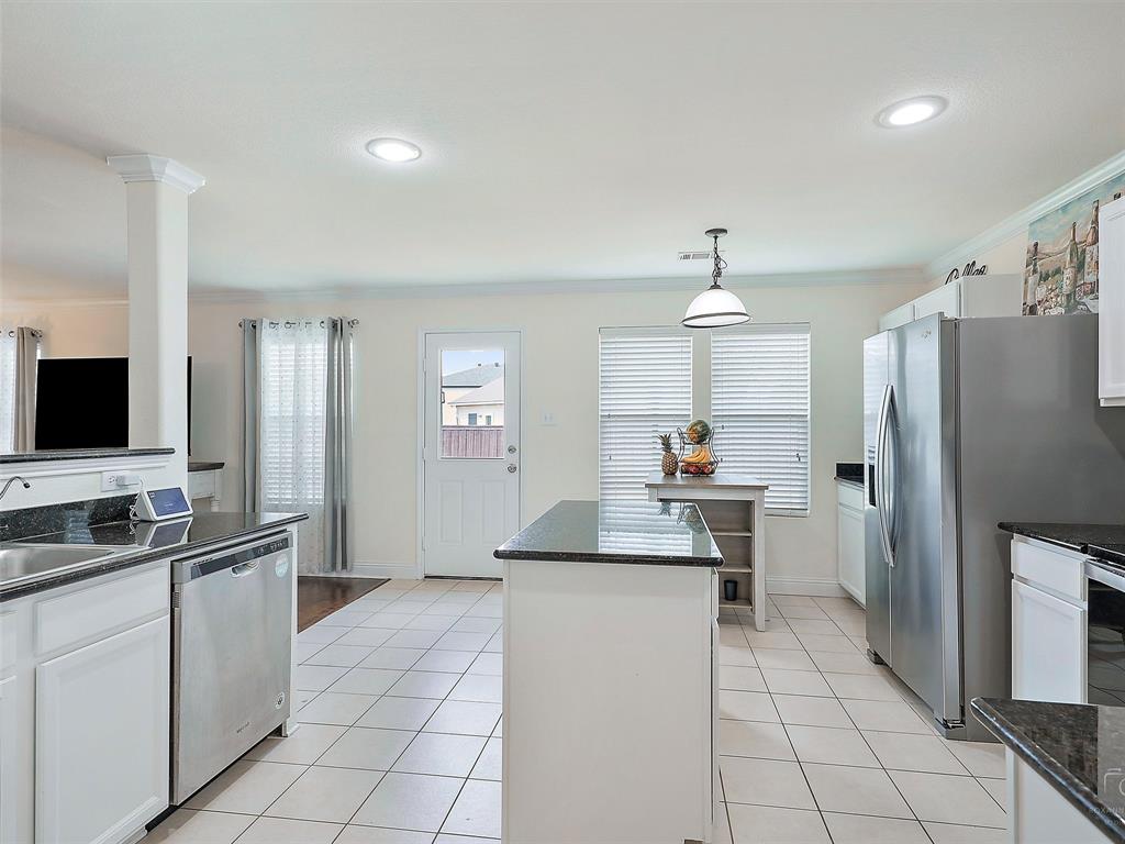 2549 Saddlehorn Drive Little Elm, TX 75068 - Photo 10 of 23 a kitchen with stainless steel appliances a sink stove and refrigerator