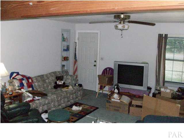 1042 Isabella Road Cantonment, FL 32533 - Photo 5 of 19 LIVING ROOM TOWARD FRONT ENTRANCE FROM KITCHEN ANGLE
