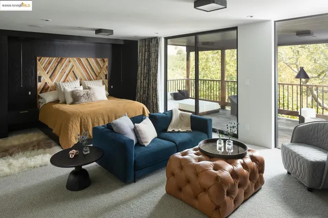 a balcony with wooden floor table and chairs