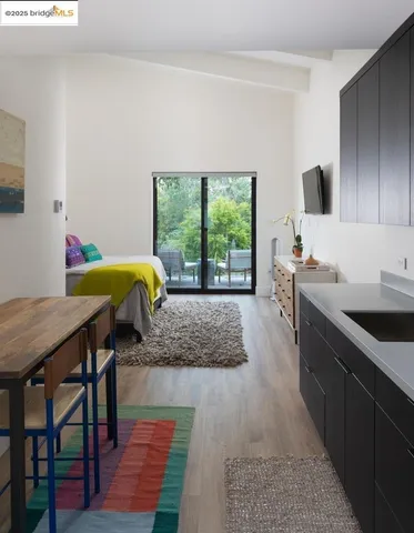 a view of a white house with a swimming pool and sitting area