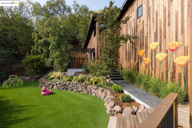 a view of a patio with table and chairs under an umbrella