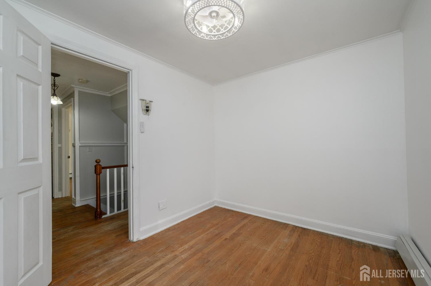 212 Echo Avenue Edison, NJ 08837 - Photo 27 of 42 a view of empty room with wooden floor and window