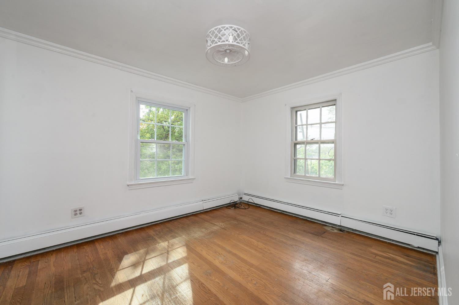 212 Echo Avenue Edison, NJ 08837 - Photo 28 of 42 wooden floor in an empty room with a window