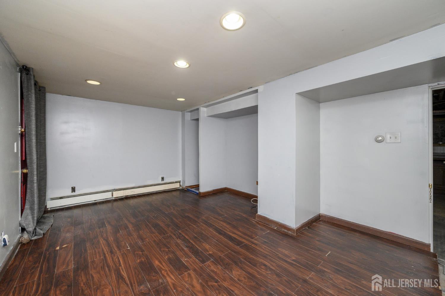 212 Echo Avenue Edison, NJ 08837 - Photo 31 of 42 a view of an empty room with wooden floor