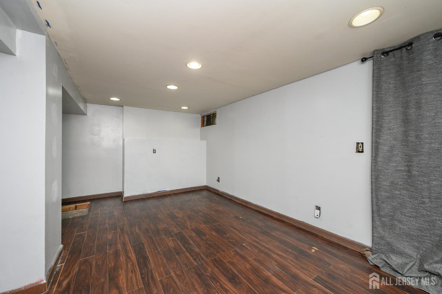 212 Echo Avenue Edison, NJ 08837 - Photo 33 of 42 a view of an empty room with wooden floor