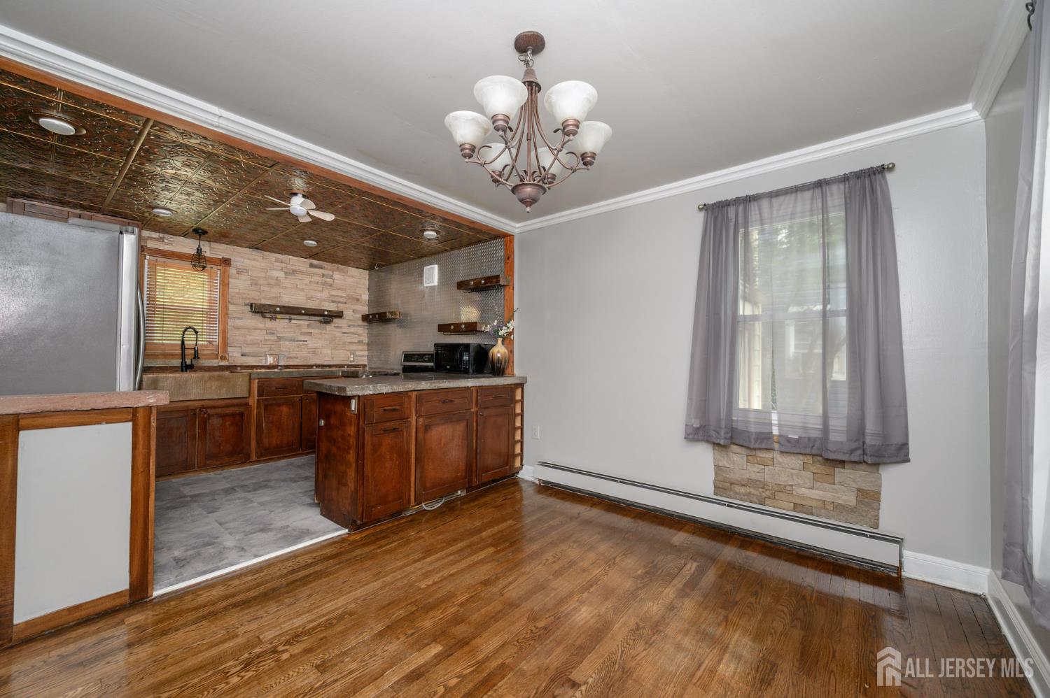 212 Echo Avenue Edison, NJ 08837 - Photo 8 of 42 a room with kitchen island granite countertop wooden floor and stainless steel appliances