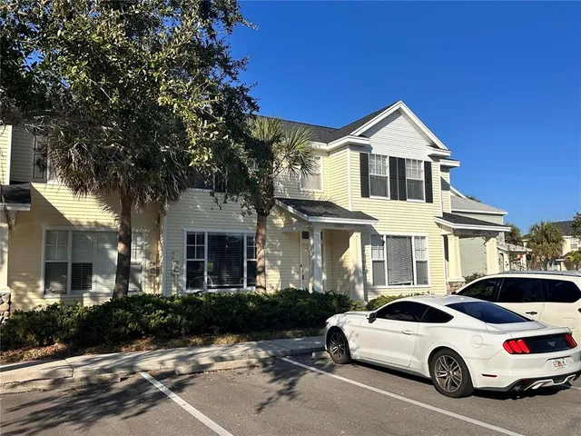 a view of a white house with a yard