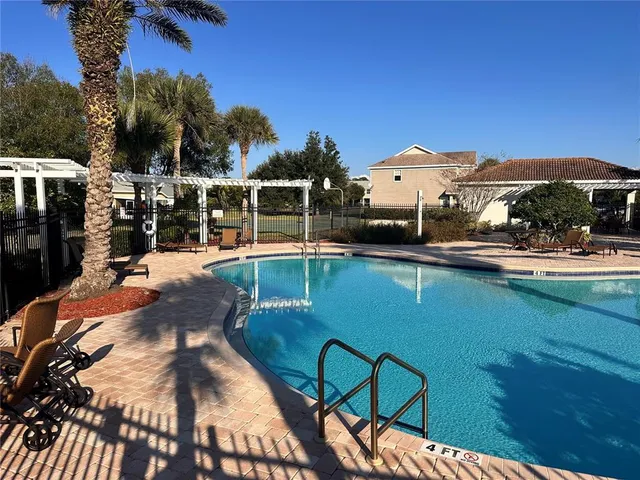 a view of a lake with couches chairs under an umbrella