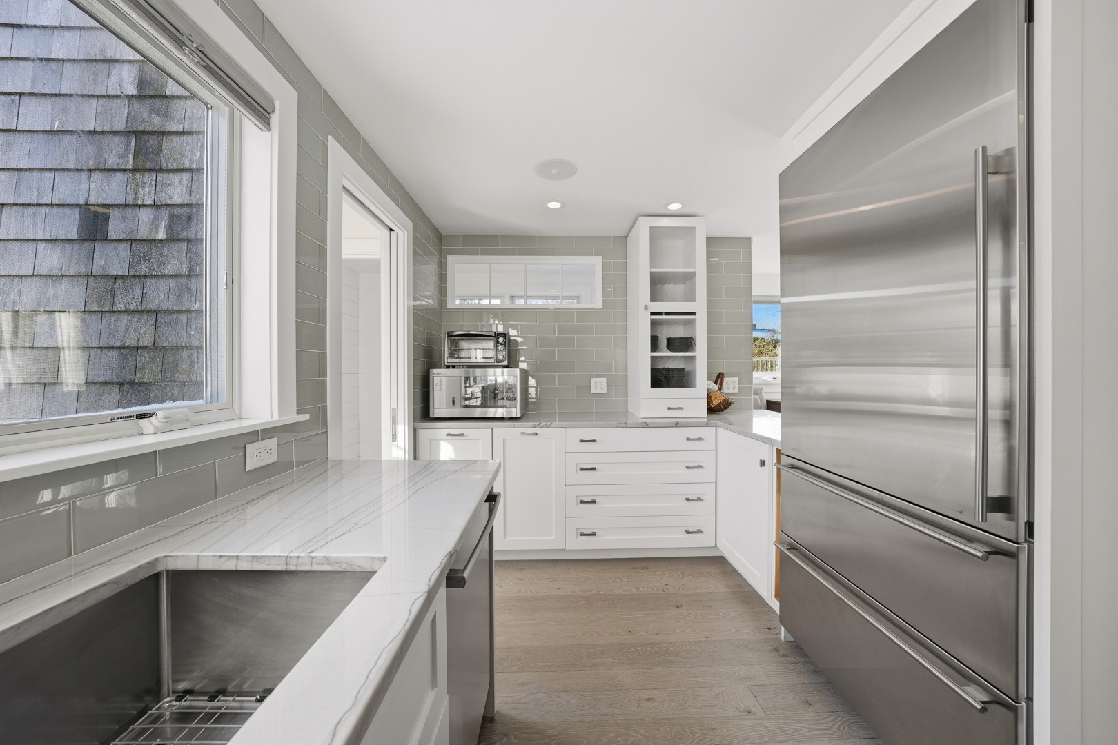 10 Pilgrim Road Nantucket, MA 02554 - Photo 20 of 65 a kitchen with a refrigerator and white cabinets