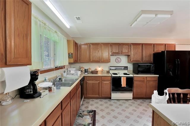 12279 Hanover Courthouse Road Hanover, VA 23069 - Photo 8 of 24 a kitchen with kitchen island granite countertop a sink stove and refrigerator