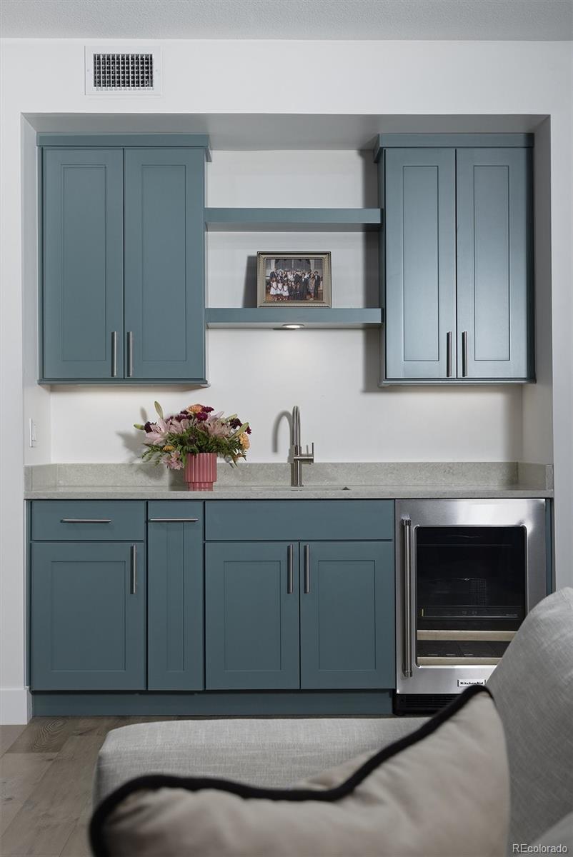 1650 Fillmore Street, Unit 1107 Denver, CO 80206 - Photo 25 of 49 a kitchen with cabinets and a fireplace