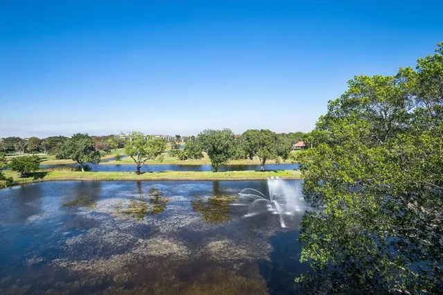 a view of a lake with houses in the background