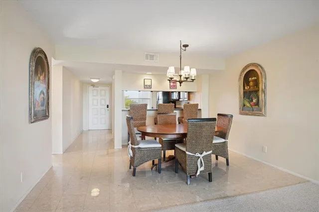 a view of a dining room with furniture and chandelier