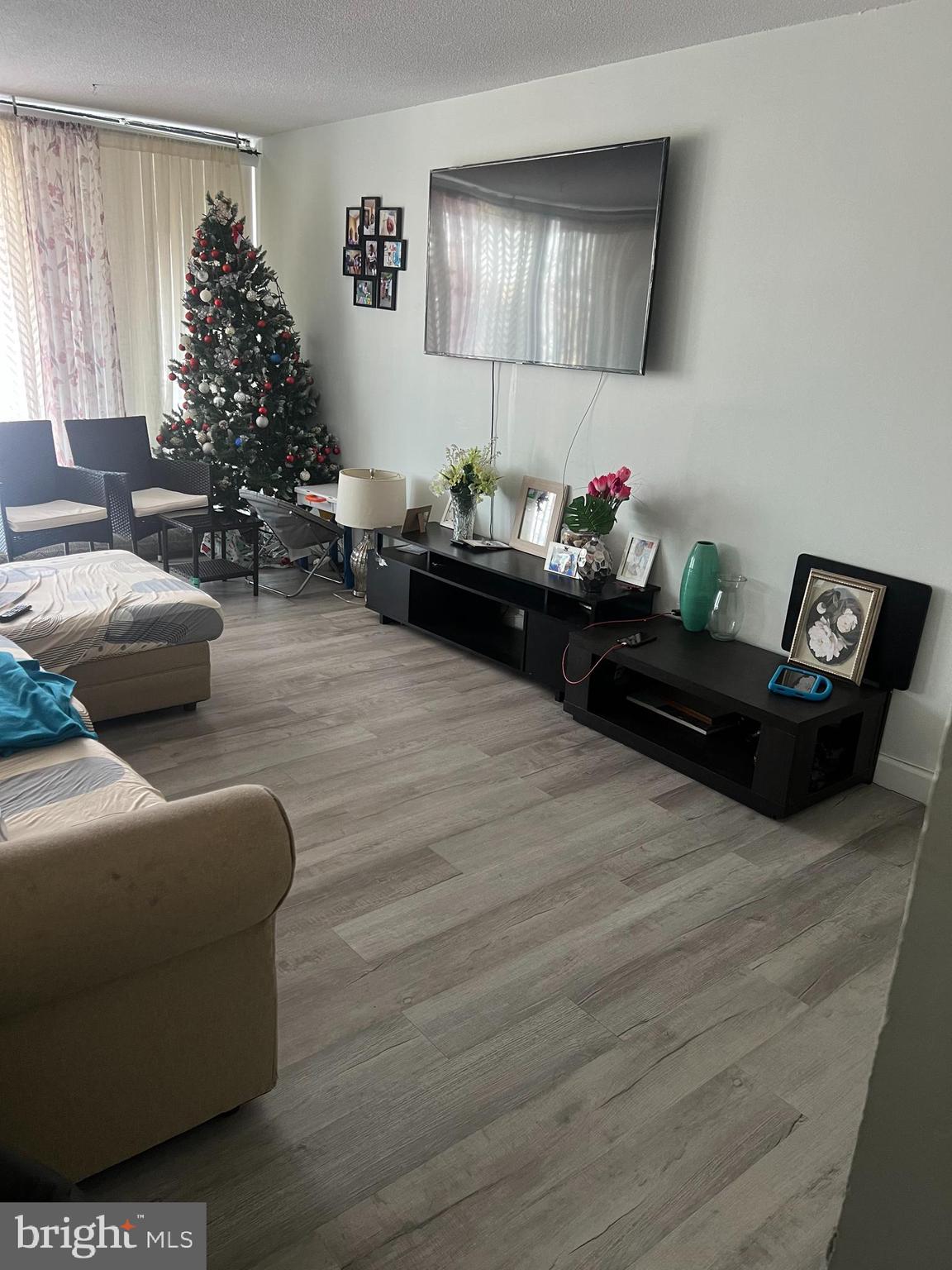 1836 Metzerott Road, Unit 422 Hyattsville, MD 20783 - Photo 11 of 12 a living room with furniture and a potted plant