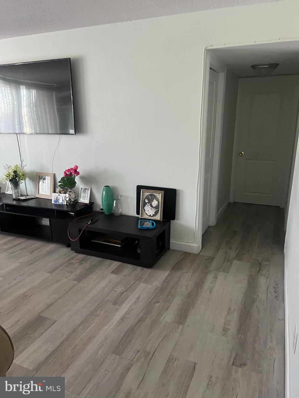 1836 Metzerott Road, Unit 422 Hyattsville, MD 20783 - Photo 12 of 12 a living room with furniture and wooden floor