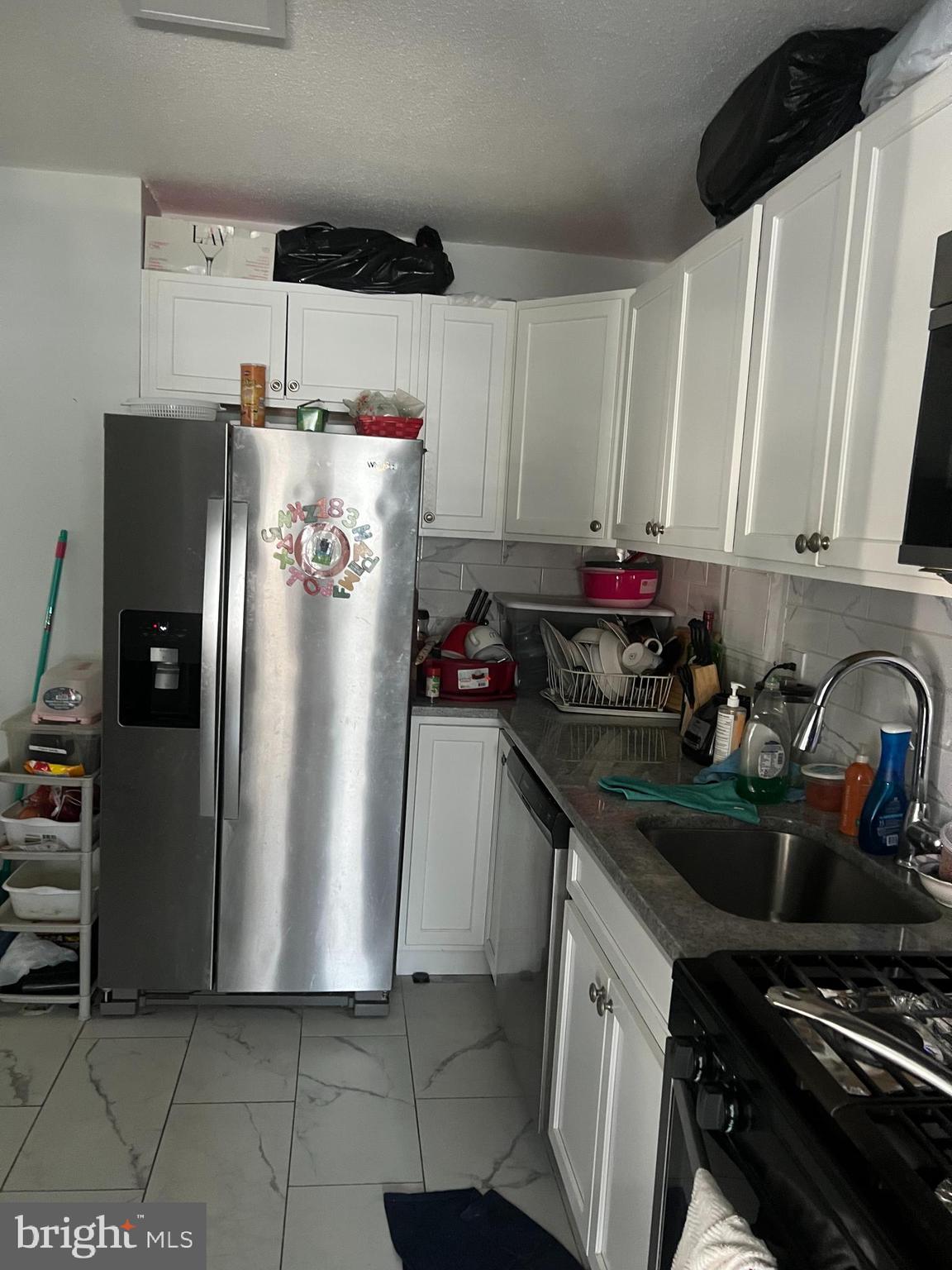 1836 Metzerott Road, Unit 422 Hyattsville, MD 20783 - Photo 7 of 12 a kitchen with stainless steel appliances a refrigerator a sink a stove and a refrigerator