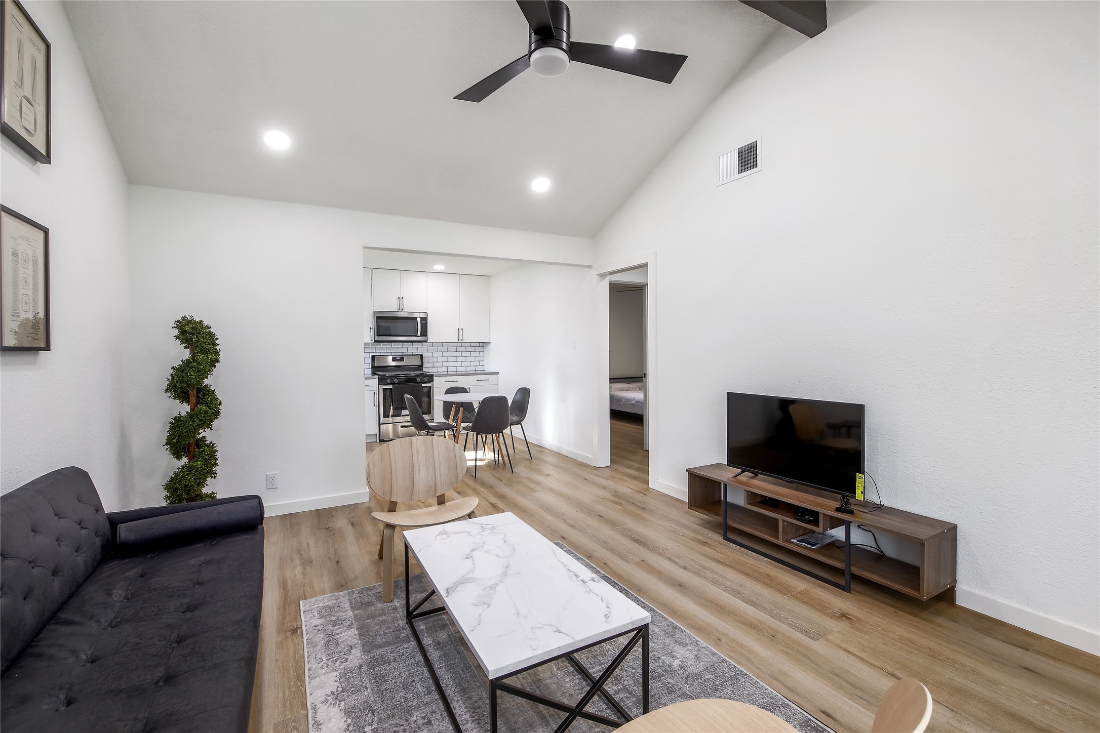 10509 Macmora Road, Unit B Austin, TX 78758 - Photo 4 of 19 a living room with furniture and a flat screen tv