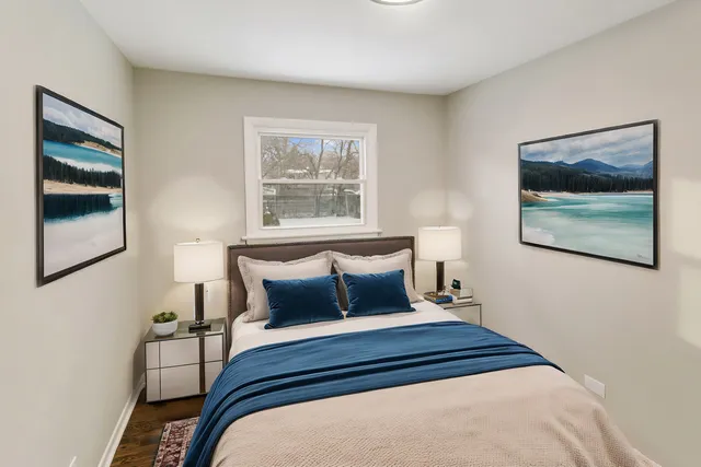 a bedroom with a bed and a painting on the wall