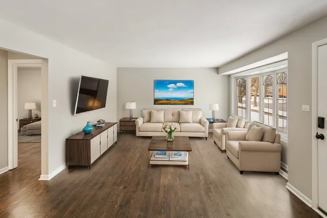 a living room with furniture flat screen tv and couches