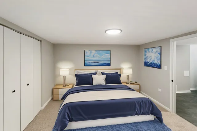 a bedroom with a large bed and a painting on the wall