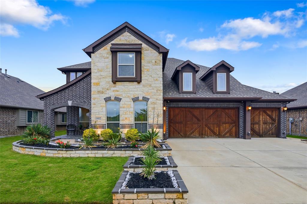1802 Roundtree Road Forney, TX 75126 - Photo 6 of 39 a front view of a house with a yard and garage