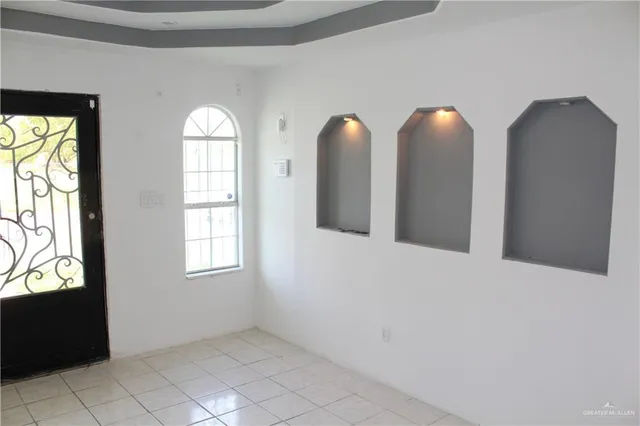 an empty room with windows and closet