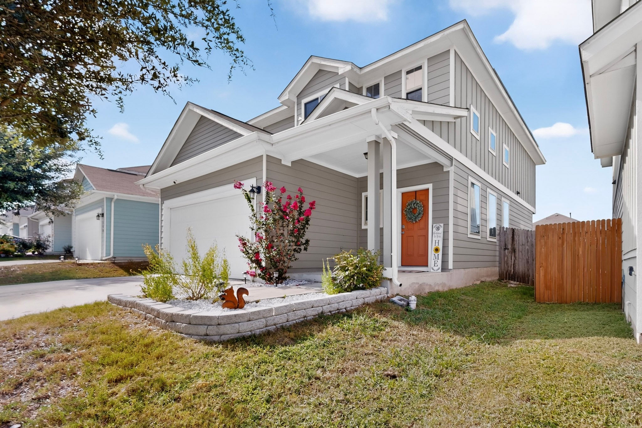 132 Wapiti Road Buda, TX 78610 - Photo 2 of 31 A welcoming entry beckons with a covered porch and tidy landscaping leading to the attached garage.