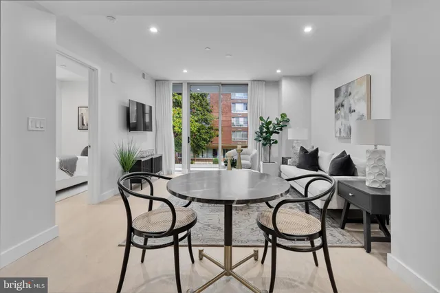 a view of a dining room with furniture and a potted plant