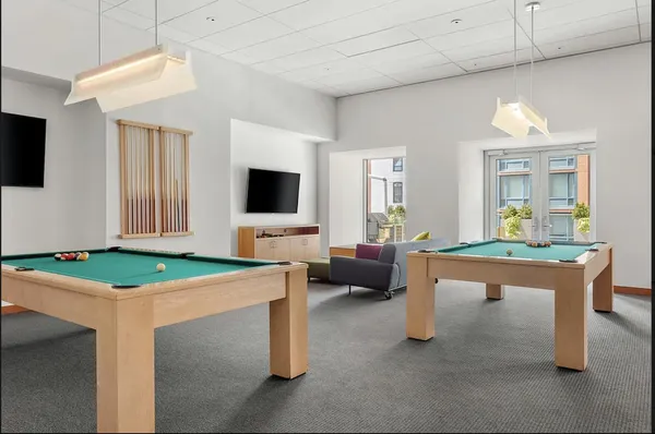 a room with furniture a flat screen tv and a table
