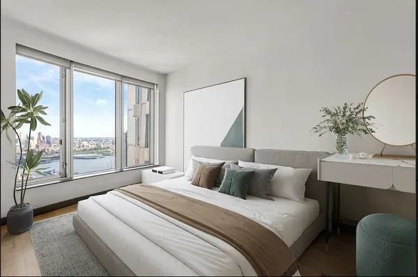 a bedroom with a large bed and a large window