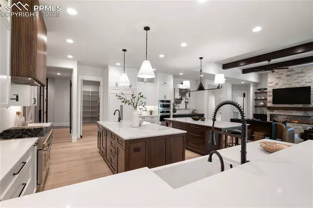 a kitchen with counter top space a sink stainless steel appliances and cabinets