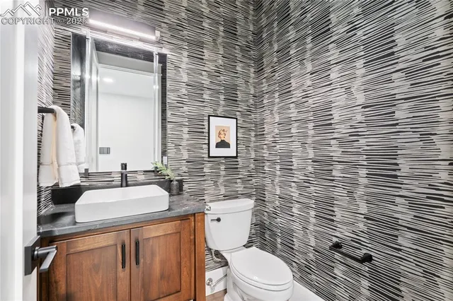 a bathroom with a sink a toilet and mirror